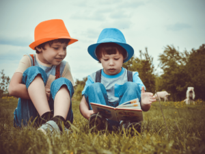 boys playing together and enjoying a read