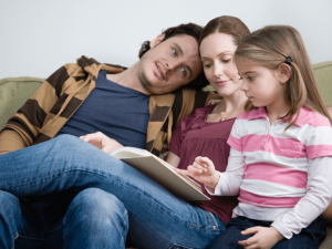parents spending time with their kids while child reads